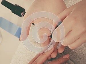 Woman in beauty salon getting manicure done.