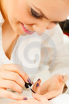 Woman in beauty salon getting manicure done.