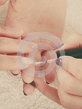 Woman in beauty salon getting manicure done.