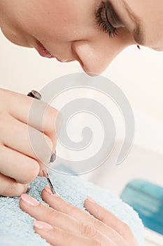 Woman in beauty salon getting manicure done.