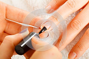 Woman in beauty salon getting manicure done.