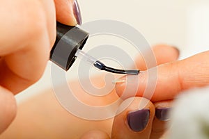 Woman in beauty salon getting manicure done.