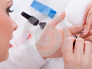 Woman in beauty salon getting manicure done.