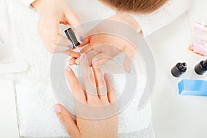 Woman in beauty salon getting manicure done.