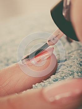 Woman in beauty salon getting manicure done