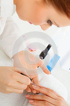 Woman in beauty salon getting manicure done