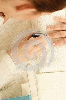 Woman in beauty salon getting manicure done