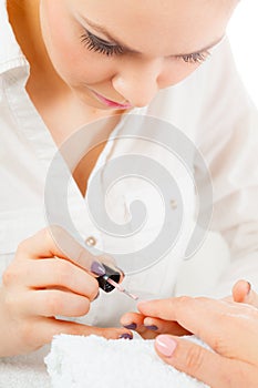 Woman in beauty salon getting manicure done