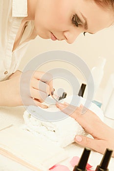 Woman in beauty salon getting manicure done.