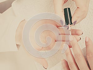 Woman in beauty salon getting manicure done.