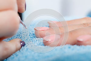 Woman in beauty salon getting manicure done.