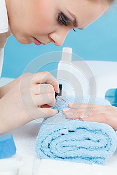 Woman in beauty salon getting manicure done.