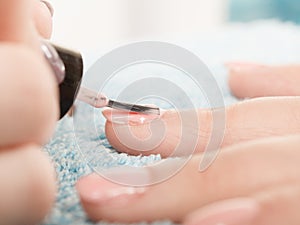 Woman in beauty salon getting manicure done.