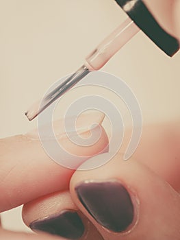 Woman in beauty salon getting manicure done.