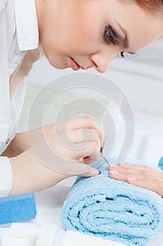 Woman in beauty salon getting manicure done.