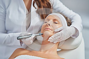 Woman in a beauty salon having needle mesotherapy treatment