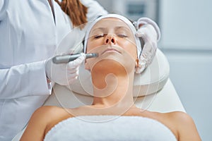 Woman in a beauty salon having needle mesotherapy treatment