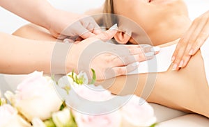 Woman in beauty studio having hair removal in the armpit region
