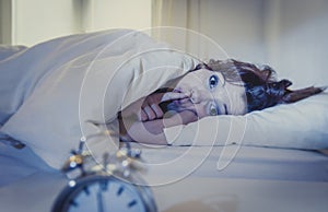 Woman in bed with insomnia that can't sleep because of noise