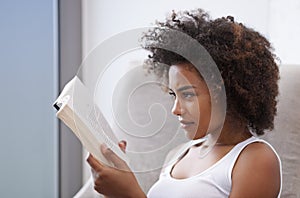 Woman, bed and reading book relax in home for holiday activity or relaxing vacation in morning, day off or weekend