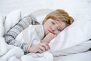 woman in bed with thermometer feverish weak suffering winter cold flu virus photo