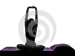 Woman in bed waking up stretching arms silhouette