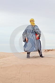 Woman in bedouin clothes in desert