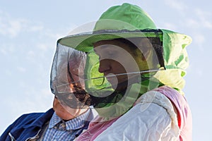 Woman beekeeper looks after bees in the hive