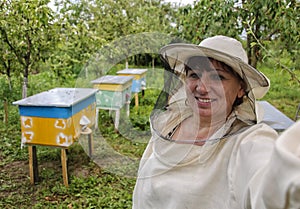 Woman beekeeper making selfie