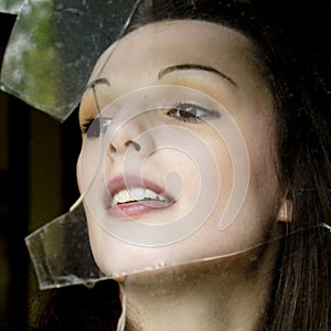 Woman behind a broken window.