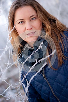 Woman behind frosty twigs