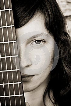Woman behind guitar fretboard