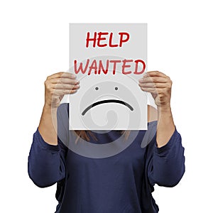 Woman behind help wanted banner