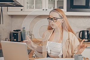 Woman behind laptop works from home.  The student submits a report online. The girl teaches courses, lectures on the Internet.