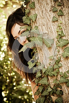 Woman behind leaves