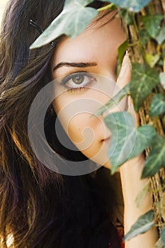 Woman behind leaves