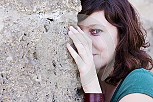 Woman behind wall