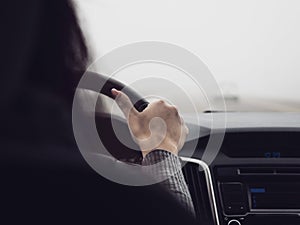 The woman behind the wheel of a car. Poor visibility when driving due to fog. Unfavorable weather conditions for driving