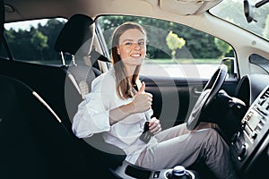 The woman behind the wheel pinches the seat belt