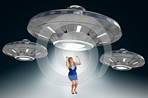 Woman being abducted by UFO - alien abduction concept