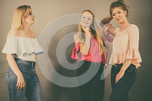 Woman being gossiped by two females