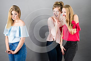 Woman being gossiped by two females