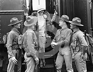 Woman being greeted by four soldiers