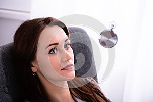 Woman being hypnotized with pendulum photo