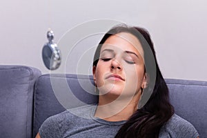 Woman Being Hypnotized While Sitting On Sofa