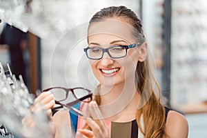 Woman being satisfied with the new eyeglasses she bought in the store