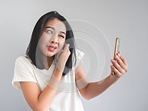 Woman being shouted from smartphone.