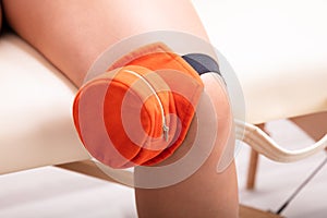 Woman Being Treated With Moxibustion Treatments On Her Knee