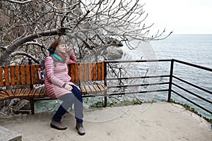 Woman on a bench at Chekhov`s dacha in spring