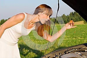 Woman bent over car engine